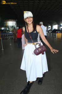 actress mrunal thakur in a black top and white skirt at airport