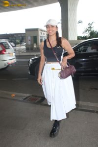 actress mrunal thakur in a black top and white skirt at airport