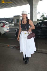 actress mrunal thakur in a black top and white skirt at airport