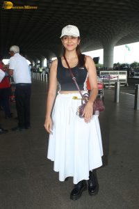 actress mrunal thakur in a black top and white skirt at airport