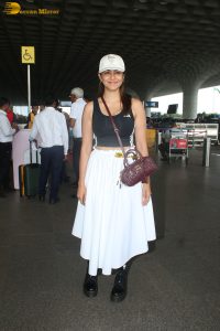actress mrunal thakur in a black top and white skirt at airport