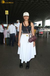 actress mrunal thakur in a black top and white skirt at airport