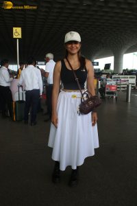 actress mrunal thakur in a black top and white skirt at airport