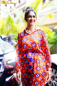 Actress Mrunal Thakur in a orange dress