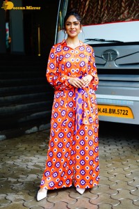 Actress Mrunal Thakur in a orange dress