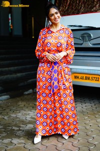 Actress Mrunal Thakur in a orange dress