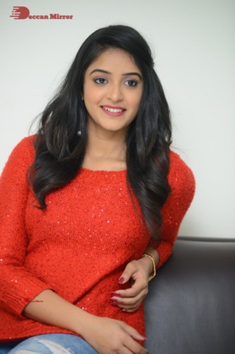 Telugu Actress Nakshatra photoshoot in a orange top and jeans