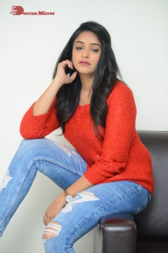 Telugu Actress Nakshatra photoshoot in a orange top and jeans