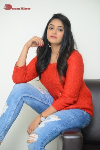 Telugu Actress Nakshatra photoshoot in a orange top and jeans