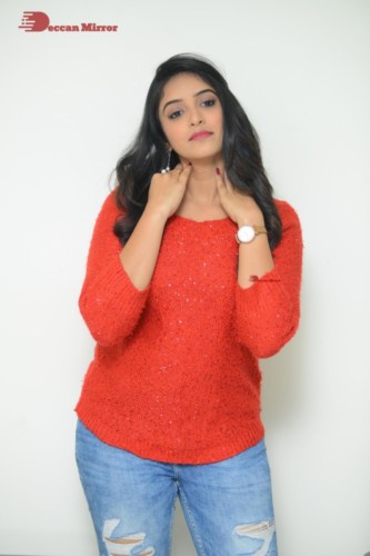 Telugu Actress Nakshatra photoshoot in a orange top and jeans