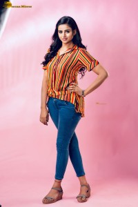 actress Naveena Reddy in a orange shirt and denim jeans