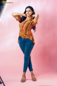 actress Naveena Reddy in a orange shirt and denim jeans