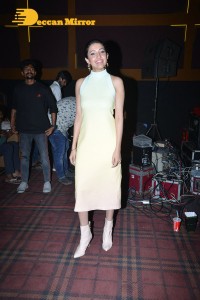 Neha Shetty in a light yellow dress attending a movie function