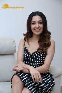 Neha Shetty in a black dress with white dots