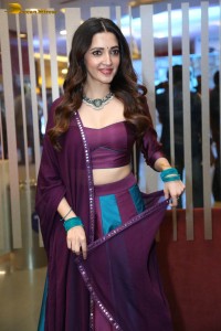 actress neha shetty in a low neck purple blouse
