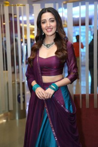 actress neha shetty in a low neck purple blouse