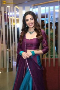 actress neha shetty in a low neck purple blouse