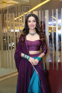 actress neha shetty in a low neck purple blouse