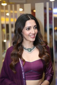 actress neha shetty in a low neck purple blouse