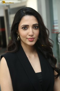 actress Neha Shetty in a black sleeveless dress