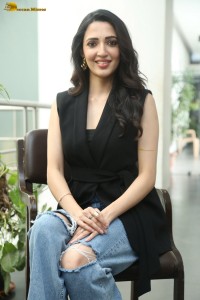 actress Neha Shetty in a black sleeveless dress