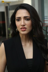 actress Neha Shetty in a black sleeveless dress