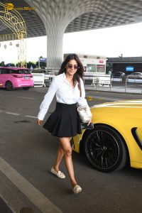 actress Nia Sharma in a white shirt and short black skirt at mumbai airport