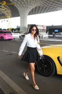 actress Nia Sharma in a white shirt and short black skirt at mumbai airport