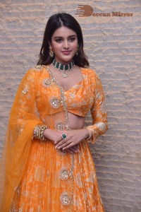 Actress Nidhhi Agerwal in a orange Lehenga Choli Dress