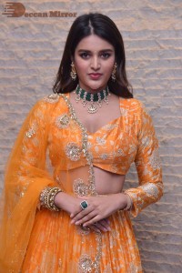 Actress Nidhhi Agerwal in a orange Lehenga Choli Dress