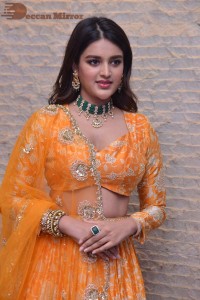 Actress Nidhhi Agerwal in a orange Lehenga Choli Dress