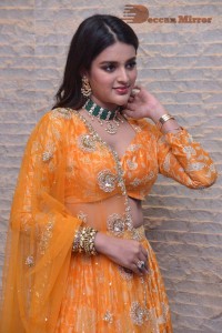Actress Nidhhi Agerwal in a orange Lehenga Choli Dress