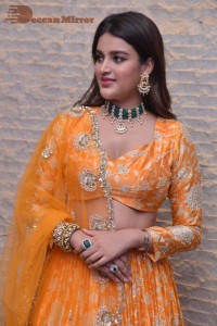 Actress Nidhhi Agerwal in a orange Lehenga Choli Dress