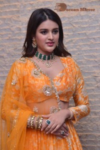 Actress Nidhhi Agerwal in a orange Lehenga Choli Dress