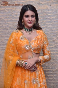 Actress Nidhhi Agerwal in a orange Lehenga Choli Dress