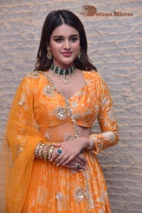 Actress Nidhhi Agerwal in a orange Lehenga Choli Dress