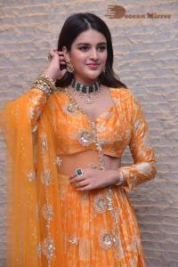 Actress Nidhhi Agerwal in a orange Lehenga Choli Dress
