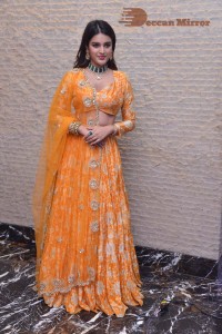 Actress Nidhhi Agerwal in a orange Lehenga Choli Dress