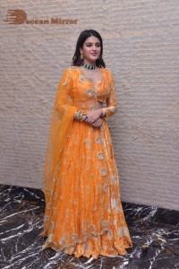 Actress Nidhhi Agerwal in a orange Lehenga Choli Dress