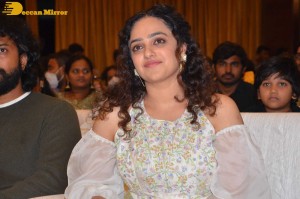 Nithya Menen in a white top and colorful skirt attending a movie function