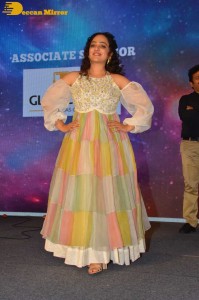 Nithya Menen in a white top and colorful skirt attending a movie function