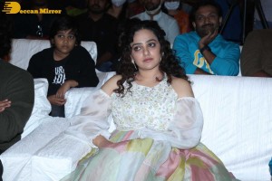 Nithya Menen in a white top and colorful skirt attending a movie function