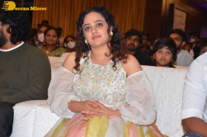 Nithya Menen in a white top and colorful skirt attending a movie function