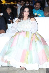 Nithya Menen in a white top and colorful skirt attending a movie function