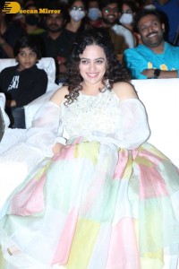 Nithya Menen in a white top and colorful skirt attending a movie function