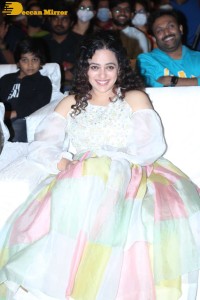 Nithya Menen in a white top and colorful skirt attending a movie function