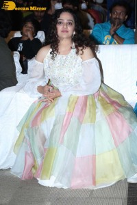 Nithya Menen in a white top and colorful skirt attending a movie function