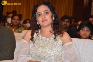 Nithya Menen in a white top and colorful skirt attending a movie function