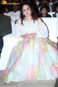Nithya Menen in a white top and colorful skirt attending a movie function