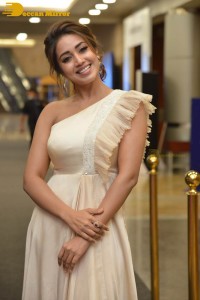 Nivetha Pethuraj in a shoulderless dress posing for photos